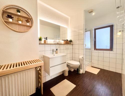 a bathroom with a toilet and a sink and a mirror at Historischer Fachwerktraum im Herzen Bambergs in Bamberg
