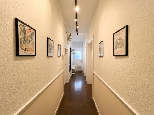 a hallway with framed pictures on the walls at Historischer Fachwerktraum im Herzen Bambergs in Bamberg