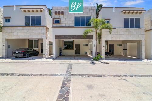 a building with a car parked in front of it at Las Villas - Townhomes & Condos in Eastside Bucerias in Bucerías