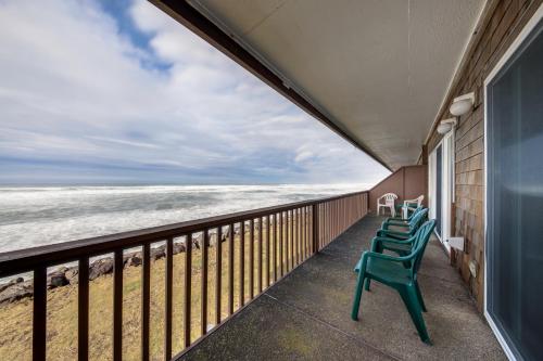 a row of chairs on a balcony looking at the ocean at Pacific Sands Resort #19A in Neskowin