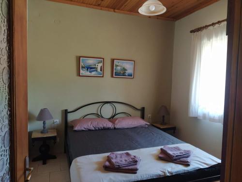 a bedroom with a bed with two towels on it at SeaSaos in Samothráki
