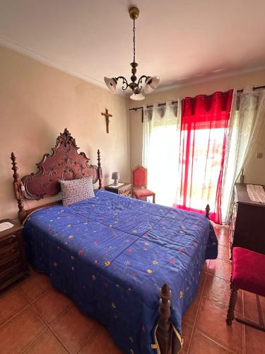 a bedroom with a bed with a blue comforter at Esposende 3 Bedrooms Balcony Center Flat in Esposende
