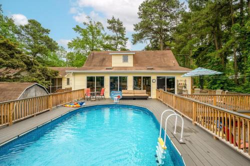 a house with a swimming pool on a deck at Whelks On Willow in Chincoteague