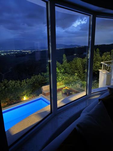 a view of a swimming pool seen from a window at Luxury SeaView Villa Pool-Bbq in Neos Voutzas