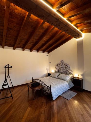 a bedroom with a bed and a wooden ceiling at La Casa negli Ulivi - con vista Mare in Arnasco