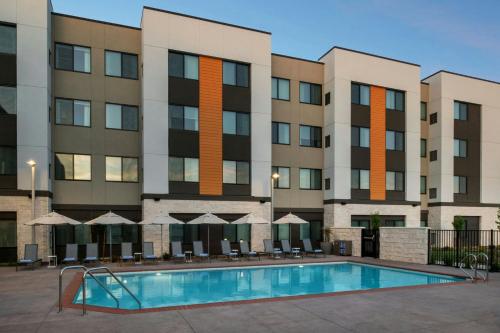 a swimming pool in front of a building at Residence Inn by Marriott Sacramento Cal Expo in Sacramento