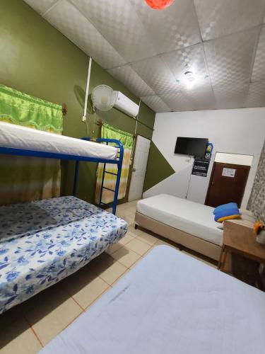 a room with two bunk beds and a tv at Hostal Leyendas in León