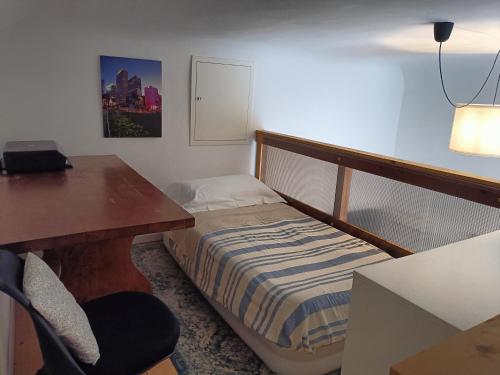 a bedroom with a bed and a desk and a table and chair at La Colonica - 3 people - 5 min from Florence in Bagno a Ripoli