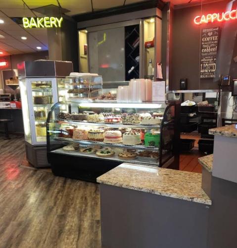a bakery with a display case filled with pastries at Chattanooga Heritage Inn in Chattanooga