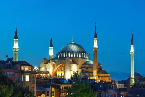 a mosque with two domes and two minarets at night at Ferman Hotel Old City -Special Category in Istanbul