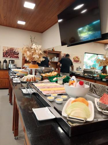 a buffet line with many different types of food at Pousada Tropicarim in Itacimirim