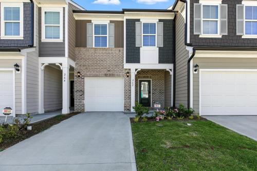 a house with two garages and a driveway at Charming Easley Retreat with Private Yard townhouse in Easley