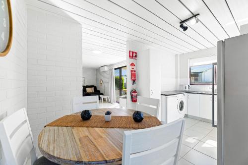 a kitchen and dining room with a table and chairs at Apollo Unit 28 Ground Floor in Narooma