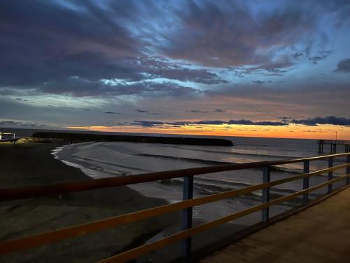 a view of the ocean from a pier at sunset at Small Home Arboletes in Arboletes
