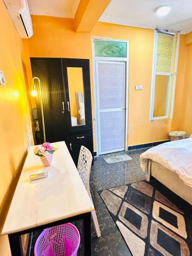 a bedroom with a bed and a table and chairs at Elegant & Modern 3-Bedroom Apartment Central Downtown Escape in Dar es Salaam
