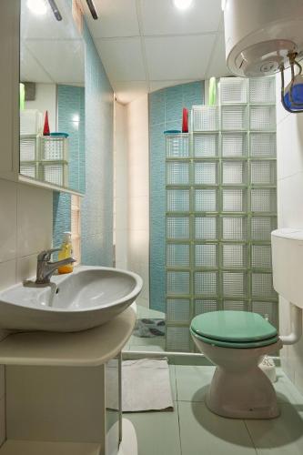 a bathroom with a sink and a toilet at Peaceful apartment with yard and parking in Skopje