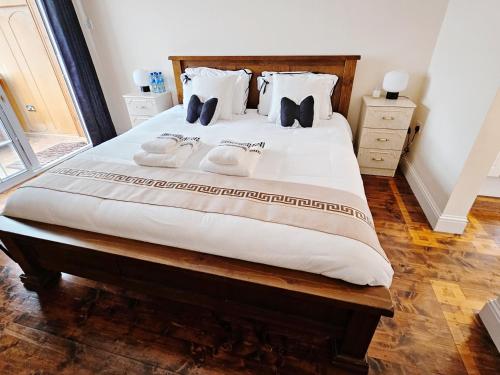 a bedroom with a large bed with two towels on it at Listowel Town in Listowel