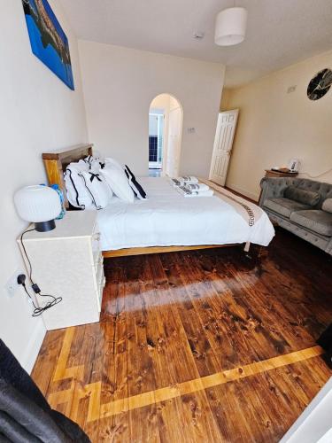 a bedroom with a large bed and a wooden floor at Listowel Town in Listowel