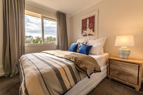 a bedroom with a bed and a window at Benwerrin House Fish Creek in Fish Creek