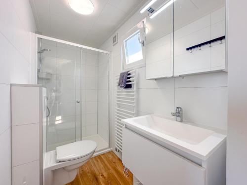 a white bathroom with a sink and a toilet at Fuut 24-28 in Breukelen
