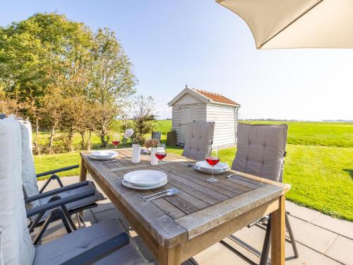 a wooden table and chairs on the patio of a house at Het Koetshuis in Zurich