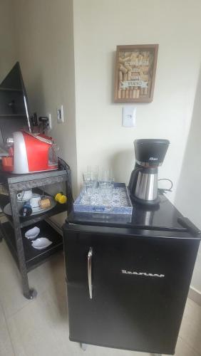 a black cabinet with a coffee maker on top of it at Casa Loft 9C in São Luís
