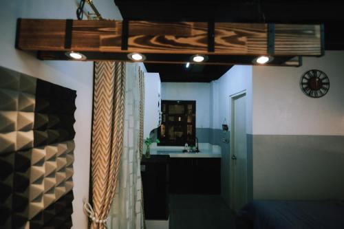 a room with a kitchen with a sink and a mirror at JM Residences 