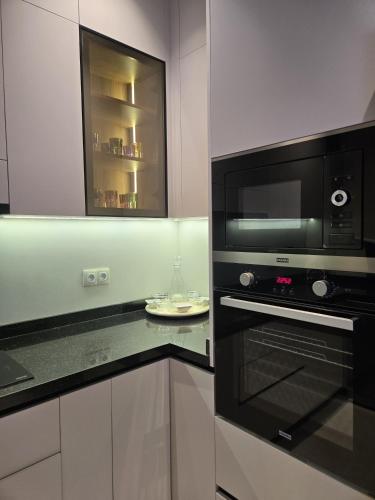 a kitchen with a microwave and a black oven at Luxury apartment in Tetouan