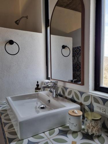 a bathroom with a white sink and a mirror at Casa Pacifico, Cerritos Beach in San Carlos