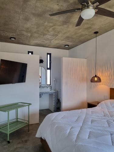 a bedroom with a white bed and a ceiling at Casa Pacifico, Cerritos Beach in San Carlos