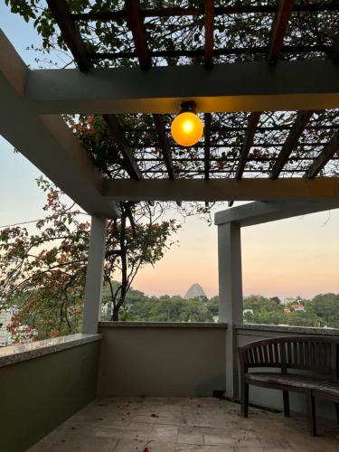 a porch with a bench and a view at Villa Christa in Rio de Janeiro