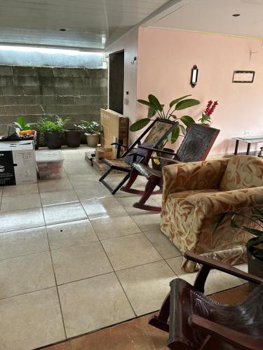 a living room with a couch and some plants at Villa Escarlata 