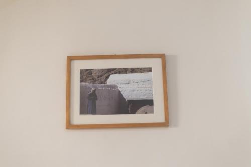 a framed picture of a man on a wall at The Bedouin Moon in Dahab