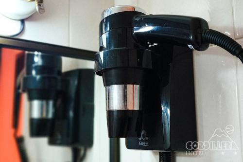 a black coffee machine is attached to a wall at Hotel Cordillera in Talca
