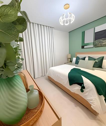 a bedroom with a bed and a vase with a plant at Gardenia in Punta Cana