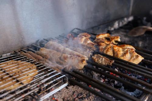 a bunch of meat cooking on a grill at The Bedouin Moon in Dahab