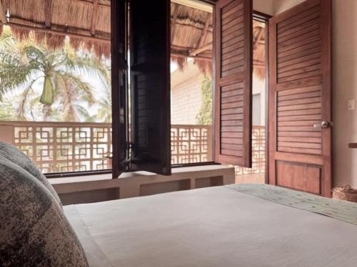 a bedroom with a bed with a view of a window at 7BR Beautiful Waterfront Villa - Perfect Getaway in Calderitas