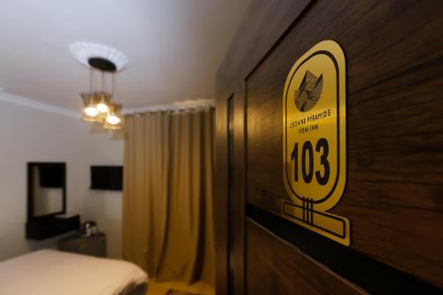 a hotel room with a sign on a wall at Crowne Pyramids View inn in Cairo