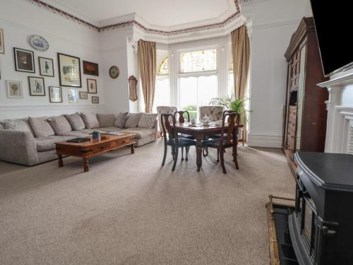 a living room with a table and a couch at Ismay Dining Room Suite - Titanic Interest in Crosby