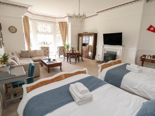 a bedroom with two beds and a living room at Ismay Dining Room Suite - Titanic Interest in Crosby