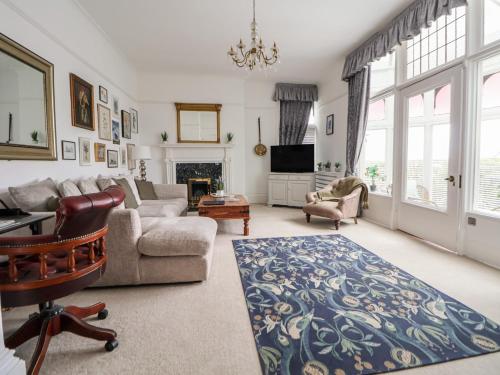 a living room with a couch and a chair at Ismay Billiard Room Apartment - Titanic Interest in Crosby