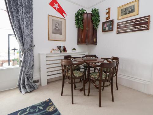 a dining room with a table and chairs at Ismay Billiard Room Apartment - Titanic Interest in Crosby
