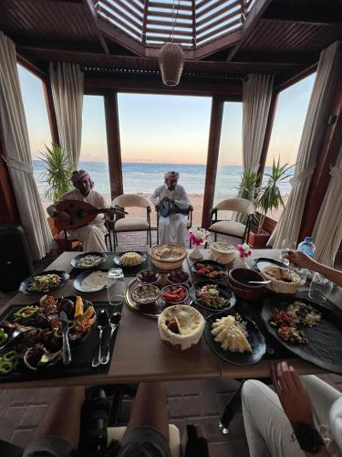 a table full of food with a view of the ocean at The Bedouin Moon in Dahab