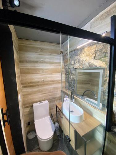 a small bathroom with a toilet and a sink at Casamar paraíso na praia com a vista do mar dos sonhos piscina e spa in Guarujá