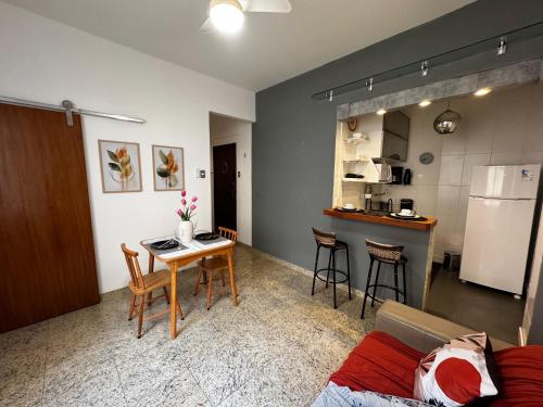 a living room with a table and a kitchen at Ao Lado do Aeroporto e VLT no Centro ABM454-72 in Rio de Janeiro