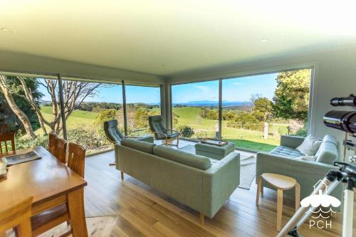 a living room with a couch and a large window at Ameys Ridge Prom Views in Foster