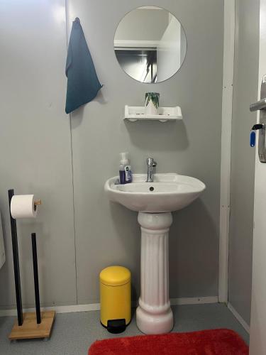 a bathroom with a sink and a mirror at Cocon Nature Matoury - Jacuzzi in Matoury