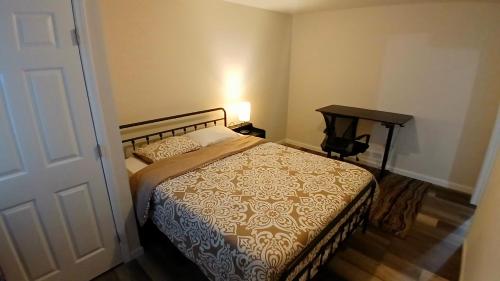 a bedroom with a bed and a nightstand with a table at Modern 2-Bedroom and 2-Bed Apartment with Private Access Door Minutes from I-81 in Hedgesville
