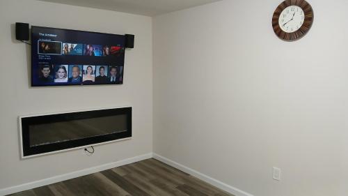 a living room with a flat screen tv on a wall at Modern 2-Bedroom and 2-Bed Apartment with Private Access Door Minutes from I-81 in Hedgesville