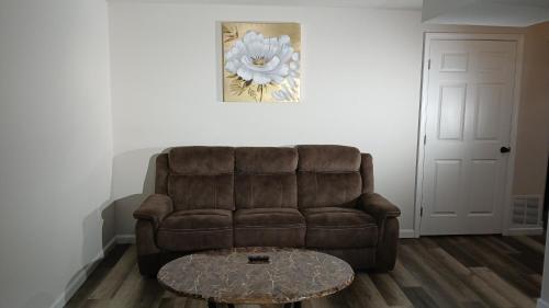 a living room with a brown couch and a coffee table at Modern 2-Bedroom and 2-Bed Apartment with Private Access Door Minutes from I-81 in Hedgesville